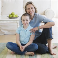 Mother and daughter sitting on floor.