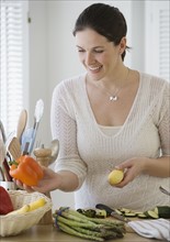 Woman chopping vegetables in kitchen.