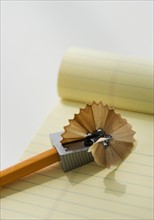 Pencil in sharpener on note pad.