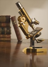 Old fashioned microscope on table.