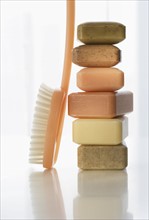 Stack of bar soap and brush.