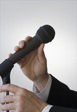 Businessman adjusting microphone.
