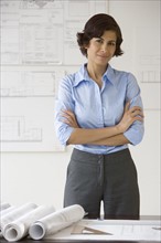Female architect with arms crossed.