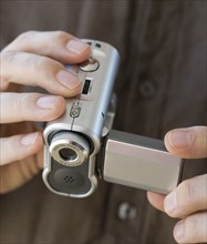 Man holding video camera.