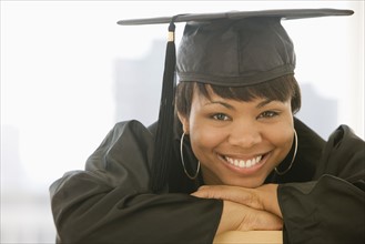 African woman wearing graduation cap and gown.