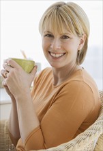 Woman holding coffee mug.