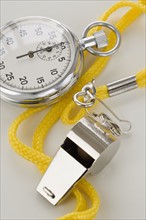 Close up of whistle and stopwatch.