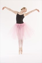 Female ballet dancer dancing on pointe.