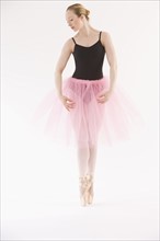 Female ballet dancer dancing on pointe.