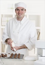 Male pastry chef in kitchen.