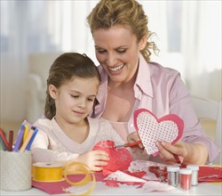 Mother and daughter making Valentines.