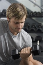 Man lifting weights at health club.