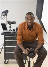 Portrait of male photographer in studio.