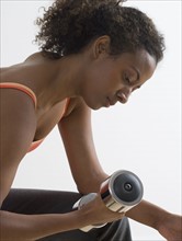 Close up of woman lifting weights.