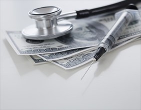 Close up of medical items and money.