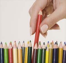 Woman choosing colored pencil.