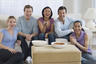 Group of friends watching television.