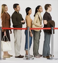 Group of people standing in line.
