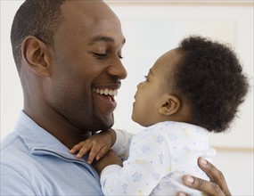 Father smiling at baby.