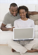 Couple looking at laptop.