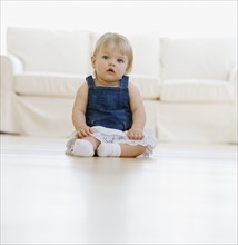 Baby sitting on floor.