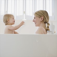 Mother and baby in bathtub.