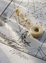 Old fashioned magnifying glass on diagram.