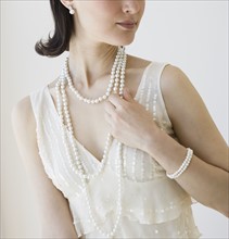 Woman wearing pearl jewelry.