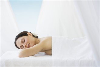 Woman laying on spa table.