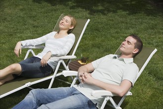 Couple sitting in lounge chairs.