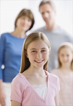 Portrait of girl in front of family.