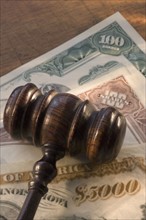 Judge’s gavel on bank notes.
