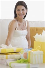 Pregnant woman with shower gifts.