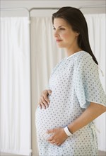 Pregnant woman in hospital gown.