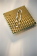 Paper clip on computer chip.