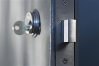 Close up of key in door lock.