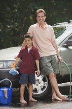 Father and son washing car.