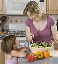 Mother and daughter smiling at each other.