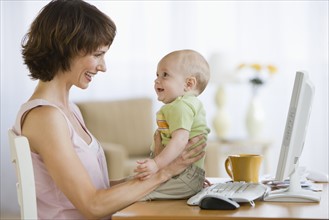 Mother and baby smiling at each other.