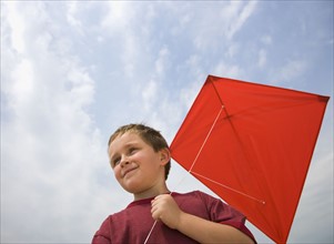 Boy holding kite.