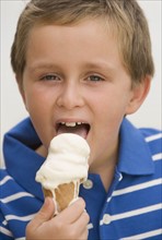 Boy eating ice cream cone.