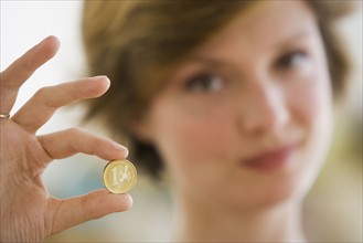 Woman holding coin.