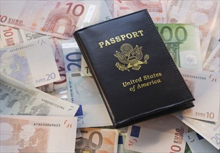 US Passport on pile of Euro banknotes.