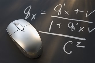 Computer mouse next to mathematical formula.