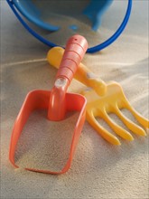 Pail and shovel toys in sand.