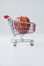 Apple in shopping cart.
