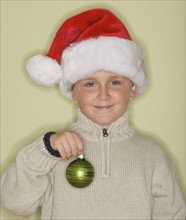 Boy wearing Santa Claus hat.