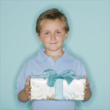 Boy holding gift.