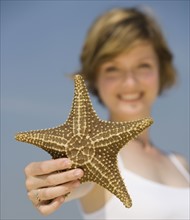 Woman holding starfish.