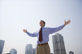 Businessman with arms outstretched.